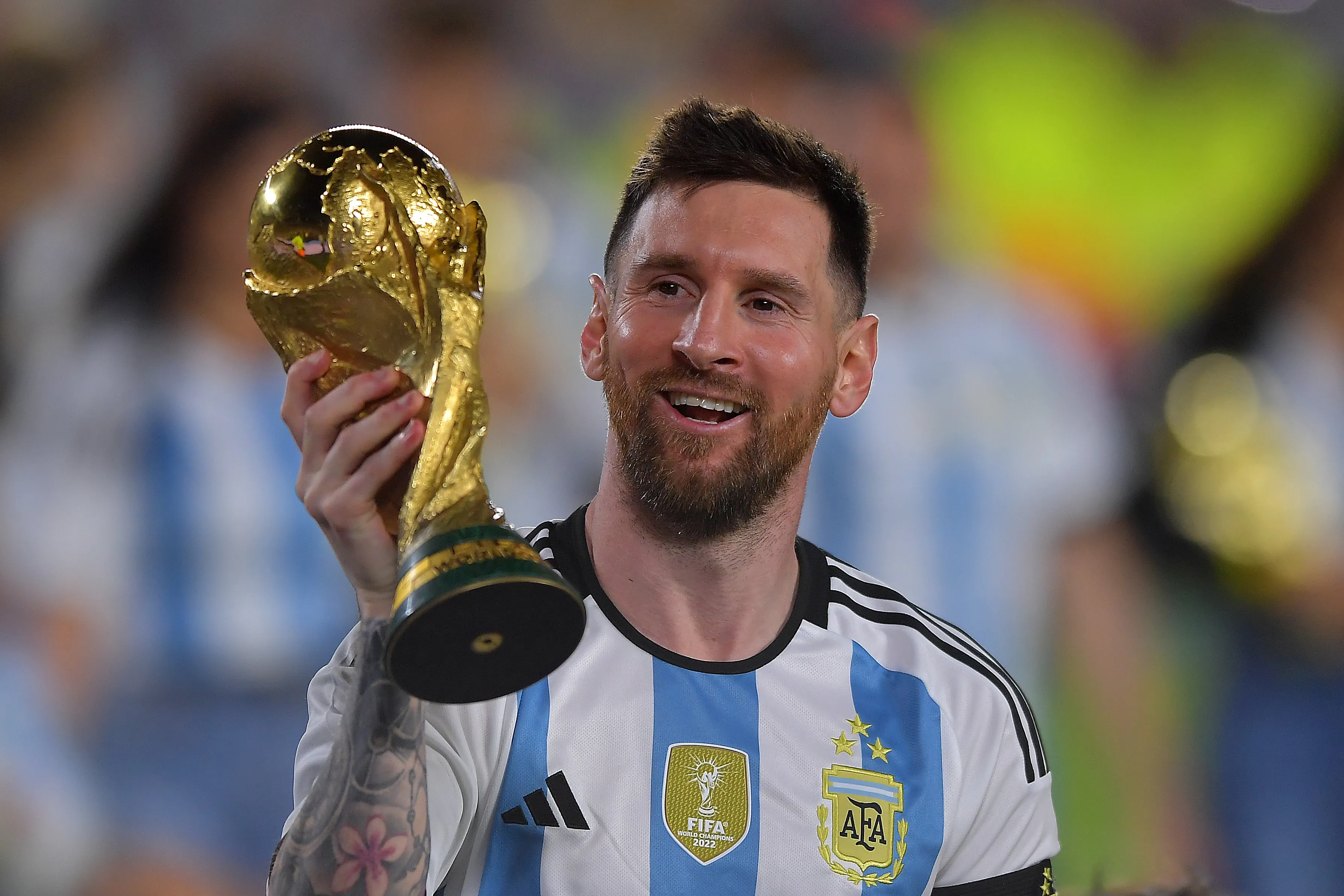 BUENOS AIRES, ARGENTINA – MARCH 23:  Lionel Messi of Argentina celebrates with the FIFA World Cup trophy during celebrations after an international friendly match between Argentina and Panama at Estadio Más Monumental Antonio Vespucio Liberti on March 23, 2023 in Buenos Aires, Argentina. (Photo by Marcelo Endelli/Getty Images)